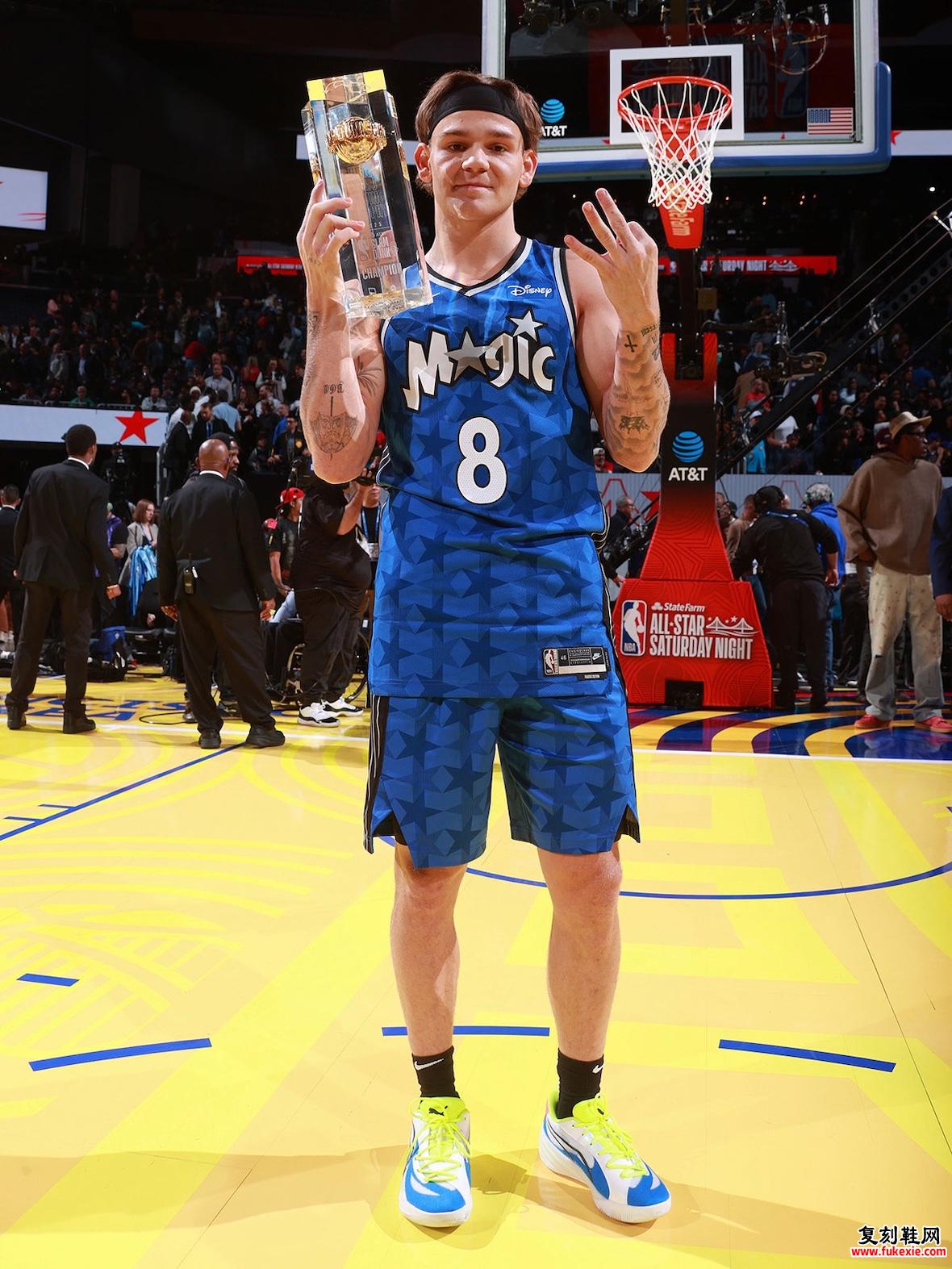 Mac McClung 穿着 PUMA All-Pro Elite 彩色领带，手里拿着扣篮大赛奖杯。